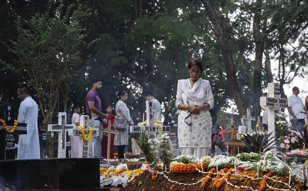 People from Christian community light candles and offer prayers on the grave of their relative during the All souls day observation, in Guwahati, India on 2 November 2024. All Souls' Day is a Christian holiday dedicated to honoring and praying for the souls of the departed