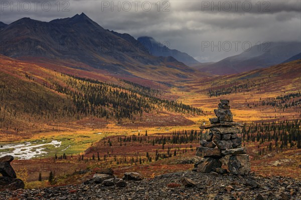 Autumn coloured tundra, mountains, clouds, Inukshuk, Tombstone Territorial Park, Dempster Highway, Yukon, Canada, North America