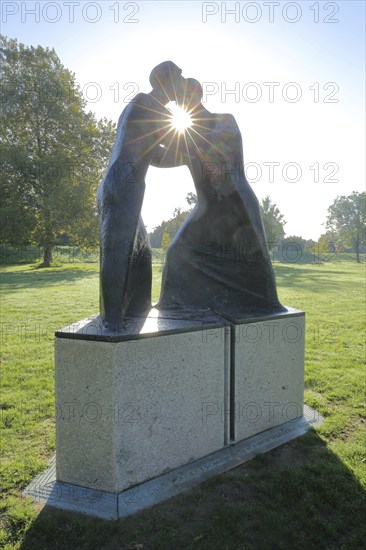 Sculpture Encounter by Josef Fromm 1994, backlight, sunbeams, two, contact, together, embrace, figures, communication, arms, grasp, touch, gesture, relationship, hole, gap, transparency, shine through, Garden of the Two Banks, Kehl, Ortenau, Baden-Württemberg, Germany, Europe