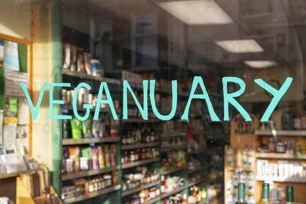 Veganuary sign in shop window whole food shop, Naturalife Taunton, Somerset, England, UK