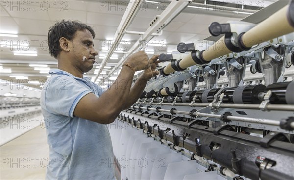 BENIN TEXTILE CORPORATION BENIN. processing cotton in a spinning mill factory near Cotonou in Benin, Glo-Djigbe, 07/03/2024. threading a yarn on a spinning machine