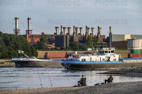 Industrial backdrop of the ThyssenKrupp Steel steelworks in Bruckhausen, on the Rhine, anglers in a bay in the Rhine near Duisburg Bärl, Duisburg, North Rhine-Westphalia, Germany, Europe