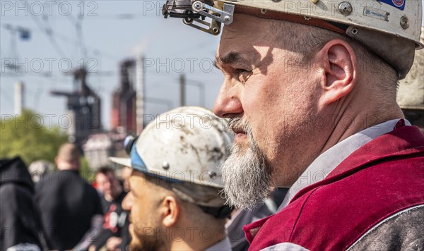 Steelworkers at a demonstration in front of the headquarters of ThyssenKrupp Steel Europe in Duisburg, against massive job cuts, after the participation of a foreign investor in the group, in the background the blast furnaces 8 and 9, Duisburg North Rhine-Westphalia, Germany, Europe