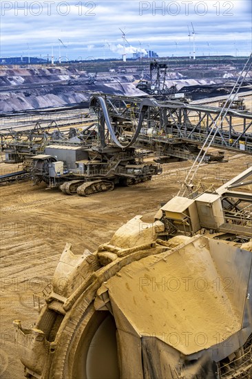 Opencast lignite mine Garzweiler 2, bucket wheel excavator 261 excavating the surface, at the rest of the hamlet of Lützerath, behind excavator 288, mining lignite, Neurath lignite-fired power station, wind farm, Erkelenz, North Rhine-Westphalia, Germany, Europe