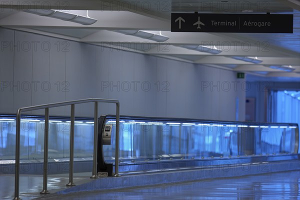 Modern airport terminal with blue illuminated walkway, handrails and minimalist design, Toronto Airport, Ontario, Canada, North America