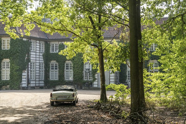 Vintage car parked in front of a historic, ivy-covered stately building surrounded by trees in the sunlight, Ordrupgaard Art Museum, Collection of Henny and Wilhelm Hansen, Ordrup, Charlottenlund, near Copenhagen, Denmark, Europe