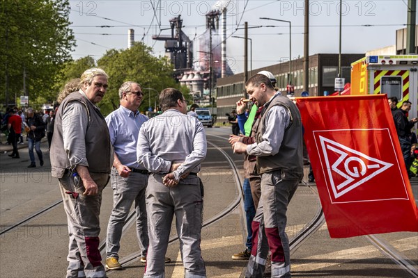 Steelworkers at a demonstration in front of the headquarters of ThyssenKrupp Steel Europe in Duisburg, against massive job cuts, after the participation of a foreign investor in the group, in the background the blast furnaces 8 and 9, Duisburg North Rhine-Westphalia, Germany, Europe