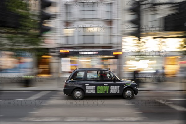 Black taxi with printed advert, wipe-clean image, London, London region, England, United Kingdom, Europe