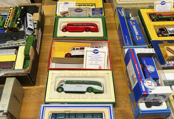 Boxes of Corgi model buses, coaches and other vehicles on display at auction, UK