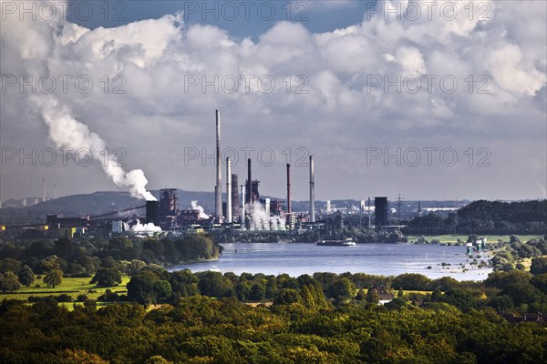 View from the Rheinpreussen spoil tip to Duisburg with ships on the Rhine and the Thyssen Krupp plant in Bruckhausen, Ruhr area, Germany, Europe