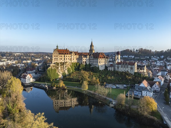 Aerial view of the town of Sigmaringen with the Hohenzollern Castle, a sight and tourist attraction above the old town and the Danube with autumnal vegetation, Danube valley, district of Sigmaringen, Baden-Württemberg, Germany, Europe