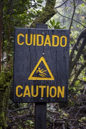 Warning sign Cuidado Caution, Attention danger of slipping, in the forest, Poás National Park, central highlands, Alajuela province, Costa Rica, Central America