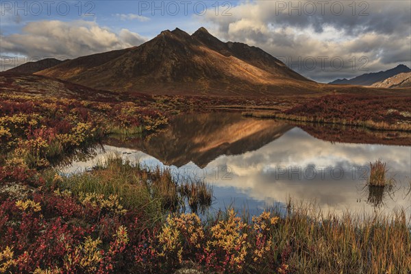 Morning light, clouds, fog, autumnal tundra, autumn colours, wilderness, mountains reflected in lake, Ogilvie Mountains, Dempster Highway, Yukon, Canada, North America