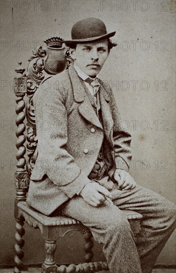 Photo of a man in a suit and bowler hat, sitting on a chair, Carte de Visite, 1890, Historical, digital reproduction of an original from the 19th century