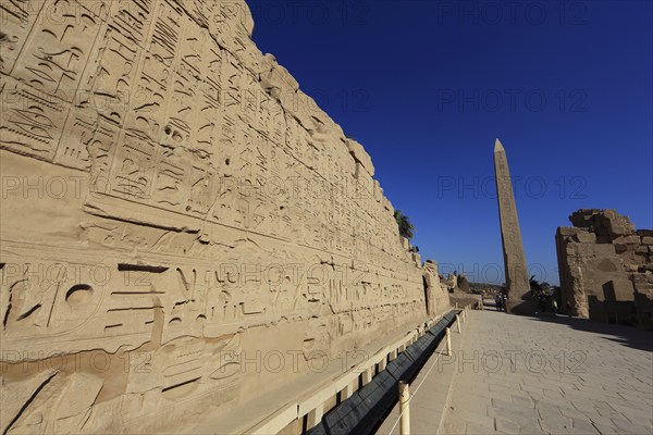 Luxor, Karnak Temple, wall with hieroglyphs, depictions and symbols in the temple complex and obelisk in Karnak, Africa, Upper Egypt, UNESCO World Heritage Site