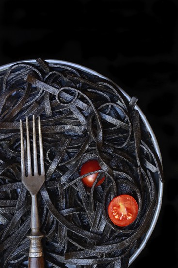 Black pasta coloured with squid ink and fork, Taglioni al Nero di Seppia, Italy, Europe