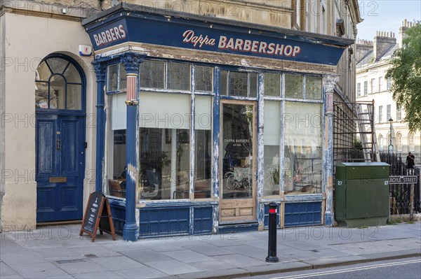 A traditional barbershop in an old shop front in the city, Bath