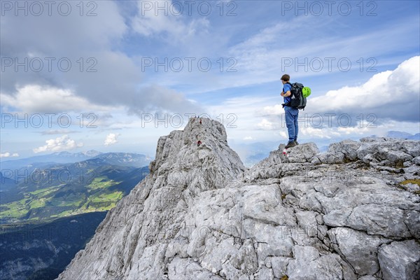 Mountaineer on a narrow rocky ridge, Watzmann crossing to Watzmann Mittelspitze, view of mountain panorama, Berchtesgaden National Park, Berchtesgaden Alps, Bavaria, Germany, Europe