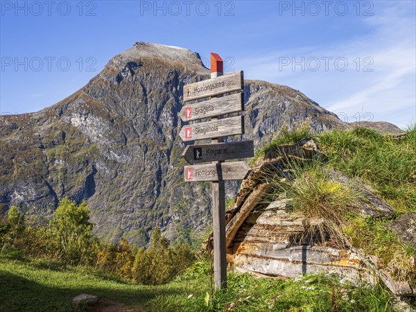 Signpost at Alpe Homlongsætra above the Geirangerfjord, traditional summer farm, Geirangerfjord, Norway, Europe