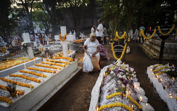 People from Christian community light candles and offer prayers on the grave of their relative during the All souls day observation, in Guwahati, India on 2 November 2024. All Souls' Day is a Christian holiday dedicated to honoring and praying for the souls of the departed