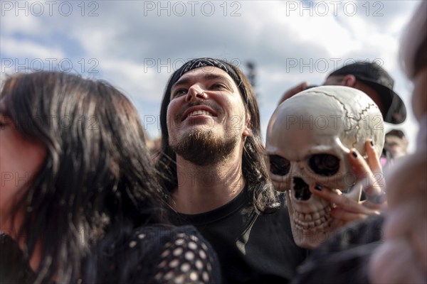 Adenau, Germany, 7 June 2024: Fan with skull at Rock am Ring. The festival takes place at the Nürburgring race track near the town of Adenau from 7 to 9 June 2024, Europe