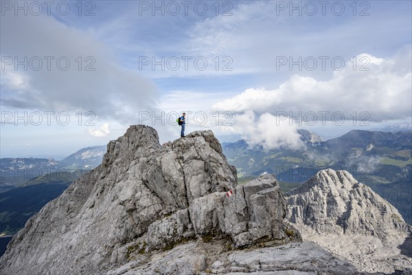 Mountaineer on a narrow rocky ridge, Watzmann crossing to Watzmann Mittelspitze, view of mountain panorama, Berchtesgaden National Park, Berchtesgaden Alps, Bavaria, Germany, Europe