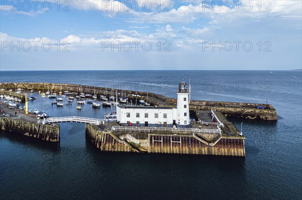 Scarborough Lighthouse and Harbour from a drone, Vincent Pier, Scarborough, North Yorkshire, England, United Kingdom, Europe