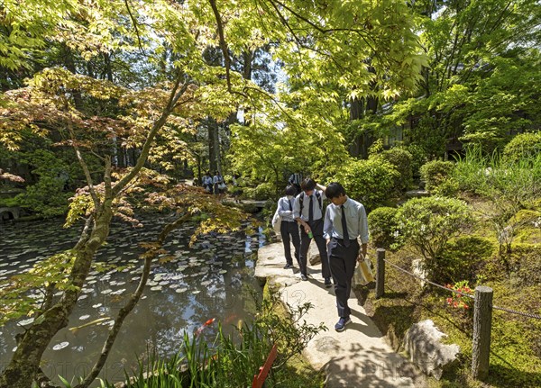 Japanese school children in uniforms visit the Tenjuan Garden, Nanzen-ji temple complex, Kyoto, Japan, Asia