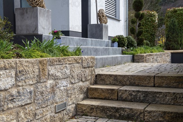 Well-kept front garden with block steps made of natural stone and granite