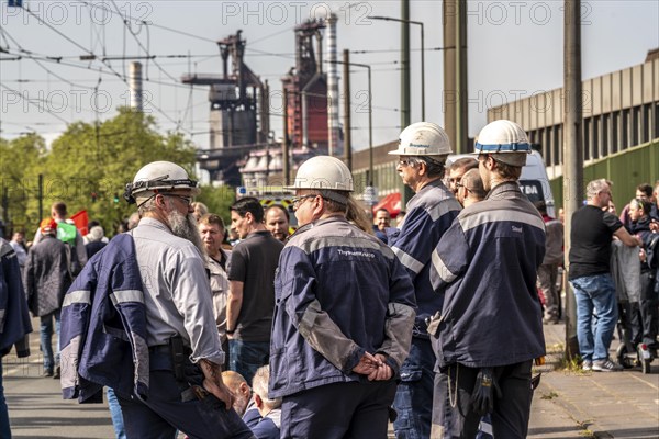 Steelworkers at a demonstration in front of the headquarters of ThyssenKrupp Steel Europe in Duisburg, against massive job cuts, after the participation of a foreign investor in the group, in the background the blast furnaces 8 and 9, Duisburg North Rhine-Westphalia, Germany, Europe