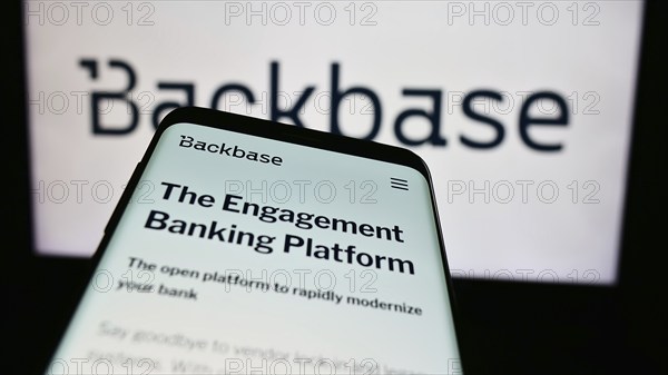 Stuttgart, Germany, 07-11-2024: Mobile phone with website of Dutch fintech company Backbase B.V. in front of business logo. Focus on top-left of phone display, Europe