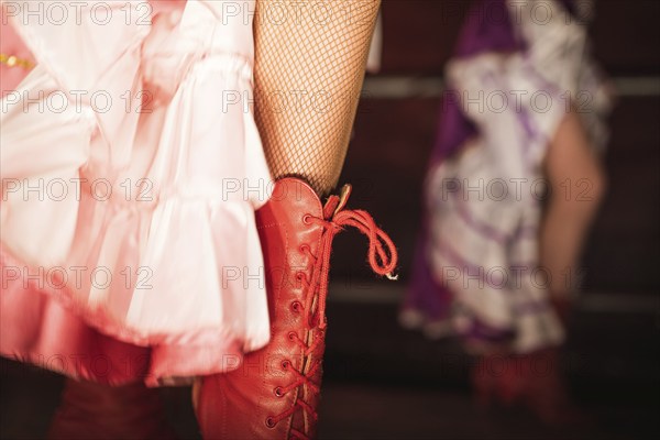 Detail of cancan dancer leg with red shoe