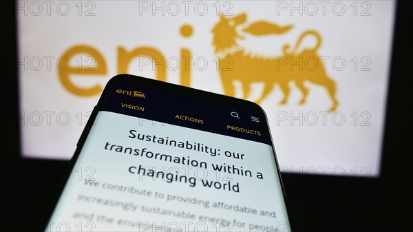 Stuttgart, Germany, 06-01-2024: Mobile phone with webpage of Italian energy company Eni S.p.A. in front of business logo. Focus on top-left of phone display, Europe