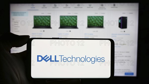 Stuttgart, Germany, 03-13-2024: Person holding cellphone with logo of US technology company Dell Technologies Inc. in front of business webpage. Focus on phone display, Europe