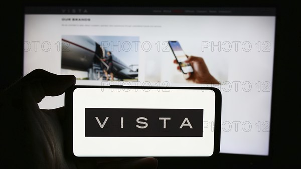 Stuttgart, Germany, 07-11-2024: Person holding cellphone with logo of Emirati aviation company Vista Global Holding Limited in front of business webpage. Focus on phone display, Europe