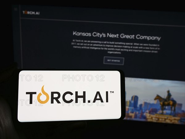 Stuttgart, Germany, 04-02-2024: Person holding smartphone with logo of US artificial intelligence (AI) company Torch Research LLC in front of website. Focus on phone display, Europe