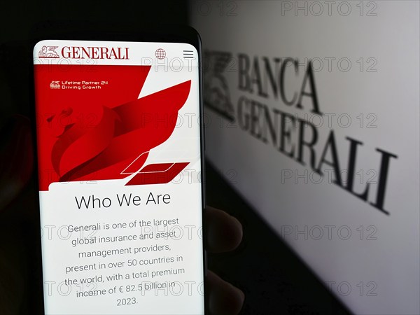 Stuttgart, Germany, 06-01-2024: Person holding smartphone with web page of Italian financial services company Banca Generali S.p.A. with logo. Focus on center of phone display, Europe