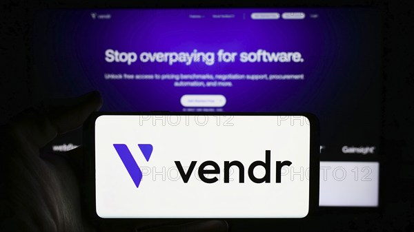 Stuttgart, Germany, 04-02-2024: Person holding mobile phone with logo of American software procurement company Vendr Inc. in front of business web page. Focus on phone display, Europe