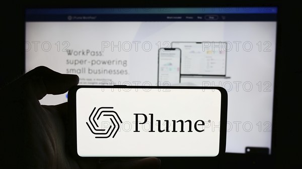 Stuttgart, Germany, 07-11-2024: Person holding cellphone with logo of US company Plume Design Inc. in front of business webpage. Focus on phone display, Europe