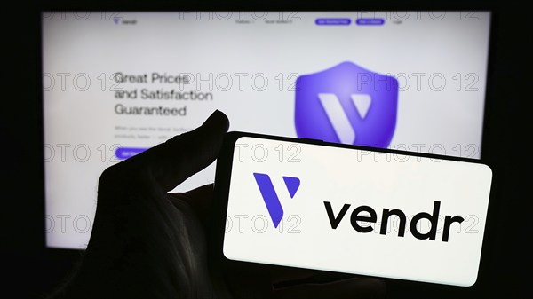 Stuttgart, Germany, 04-02-2024: Person holding cellphone with logo of US software procurement company Vendr Inc. in front of business webpage. Focus on phone display, Europe