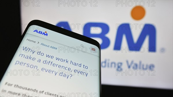 Stuttgart, Germany, 03-13-2024: Smartphone with webpage of US facility management company ABM Industries Inc. in front of business logo. Focus on top-left of phone display, Europe