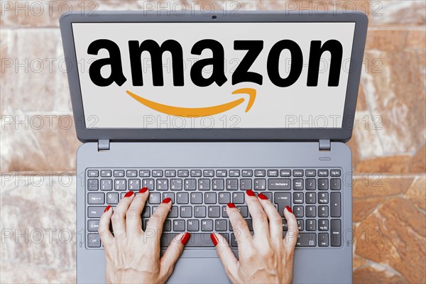 In this photo illustration, the Amazon logo is seen displayed on a laptop screen