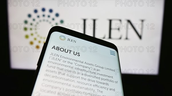 Stuttgart, Germany, 03-23-2024: Mobile phone with webpage of company JLEN Environmental Assets Group Limited in front of business logo. Focus on top-left of phone display, Europe