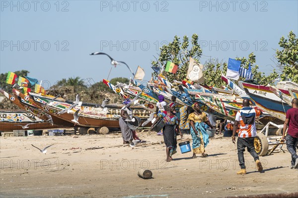 Fishermen's wives with fishing boats on the beach of Sanyang, Gambia, West Africa, Africa