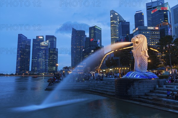 SINGAPORE, JANUARY 1, 2014: Night view of Singapore Merlion at Marina Bay against Singapore skyline. Merlion is a well-known tourist icon, mascot and national personification of Singapore