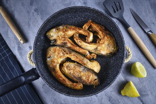 Slices of baked carp fish in a pan, a traditional Polish Christmas dish