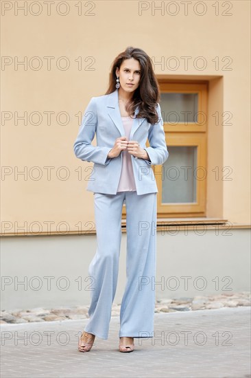 Beautiful lady in skyblue pantsuit on the street