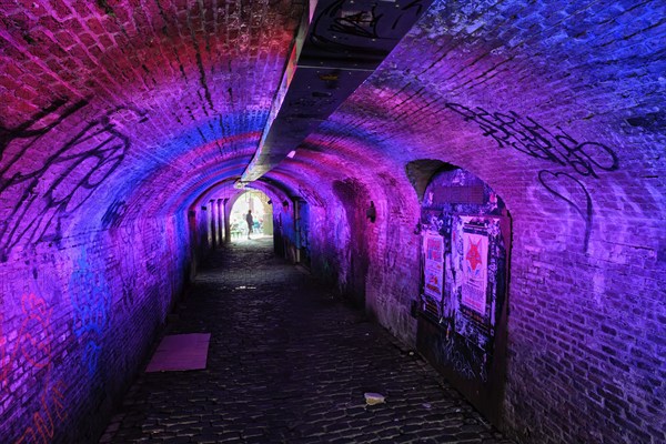 UTRECHT, NETHERLANDS, MAY 25, 2018: Illuminated Ganzemarkt tunnel to Oudegracht in the old city centre of Utrecht, Netherlands