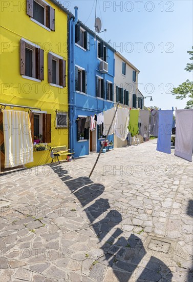 Laundry line with pieces of laundry, colourful houses, colourful house facades, alleys on the island of Burano, Venice, Veneto, Italy, Europe