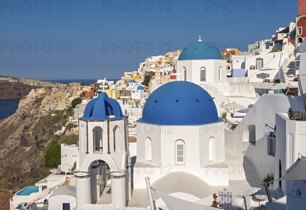 White churches with blue dome, Agios Spiridonas, St Spyridon, and Church of Anastasis, Resurrection, Ia, Oia, Santorini, Greece, Europe